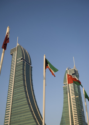 Flags flying in front of the Bahrain Financial Harbour